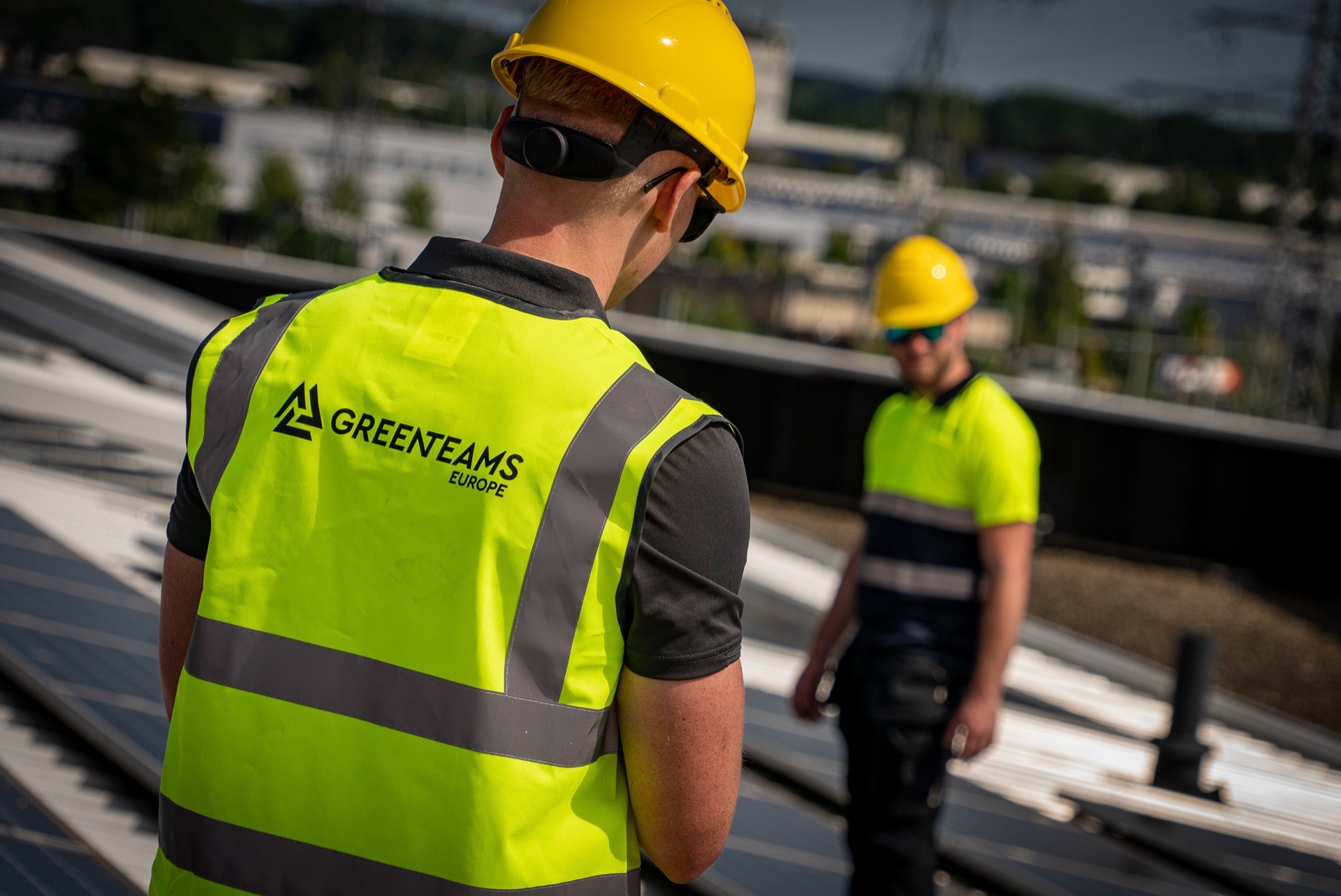 Green Teams Europe installers working on a rooftop array